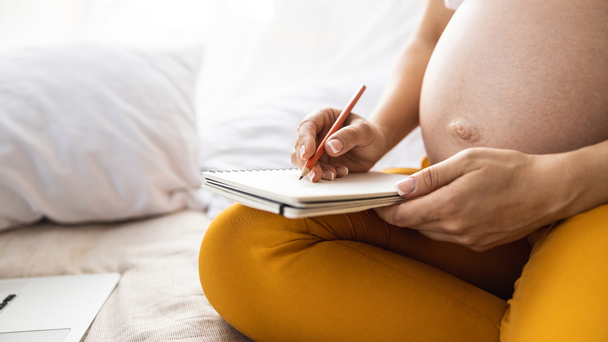 pregnant mom writes baby names