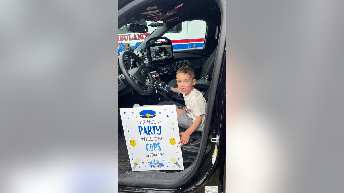 little boy in police car