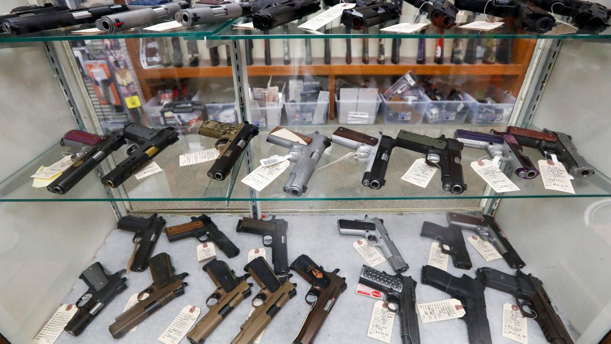 Semi-automatic handguns are on display at a gun store