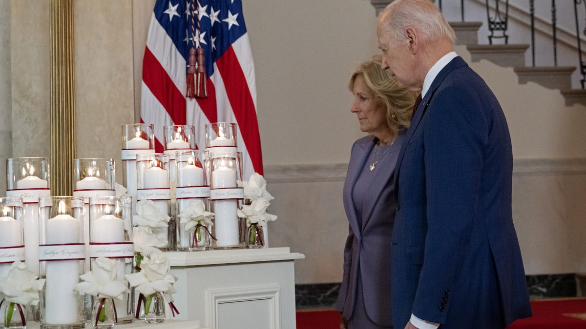 President Joe Biden and First Lady Jill Biden stand by a memorial for the 21 victims of the 2022 mass shooting in Uvalde, Texas, at the White House