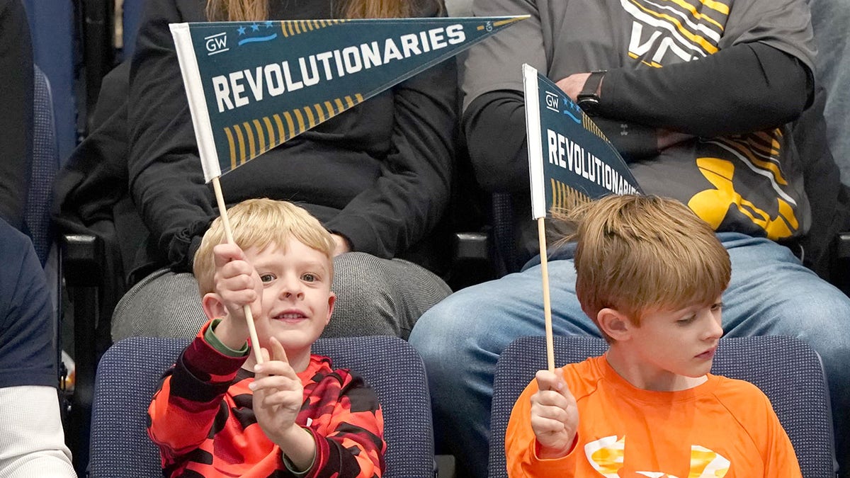 Kids holding Revolutionaries pennants