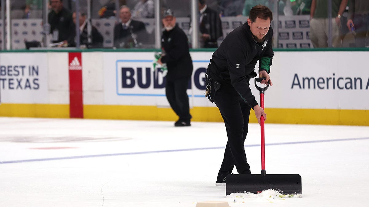 Stars employee cleaning ice