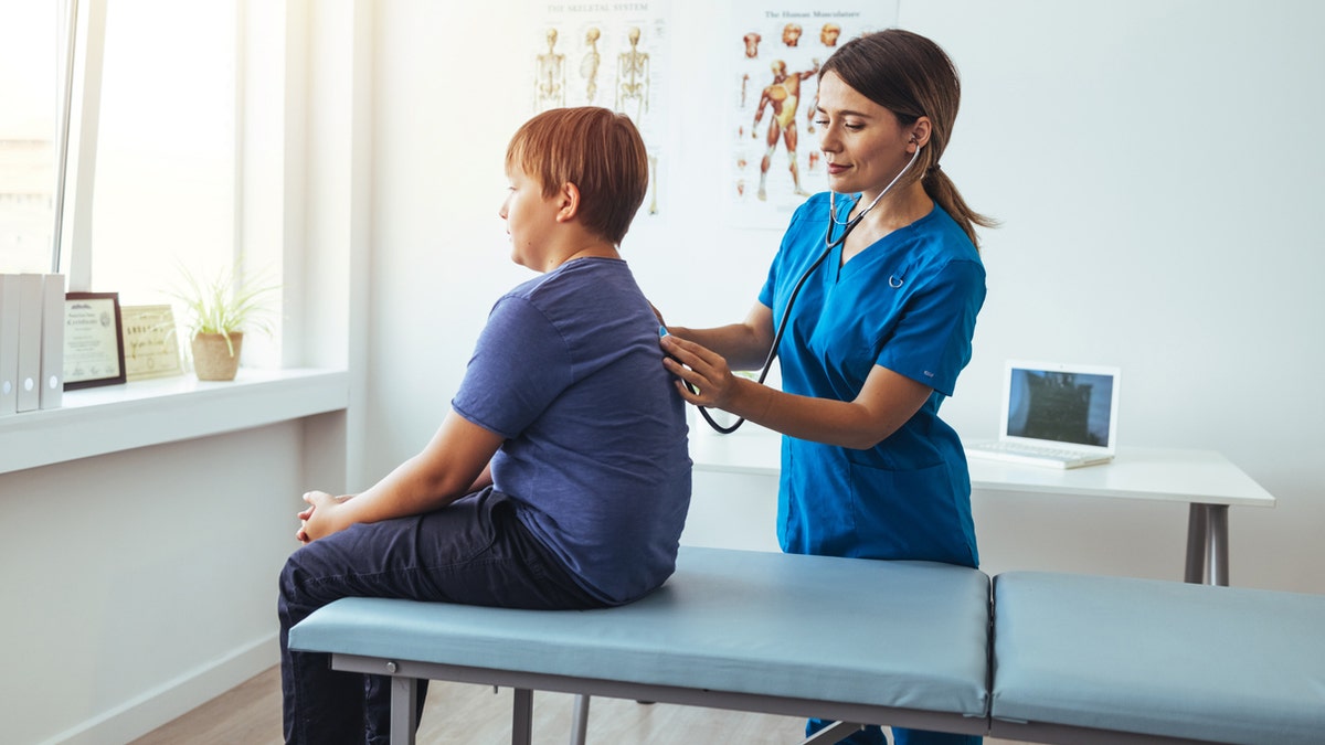 Teen boy with doctor