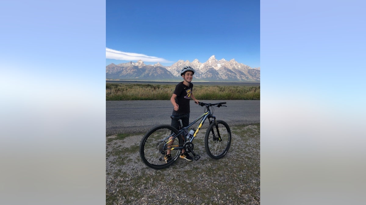 Nate Bronstein rides a bike with mountains in the background