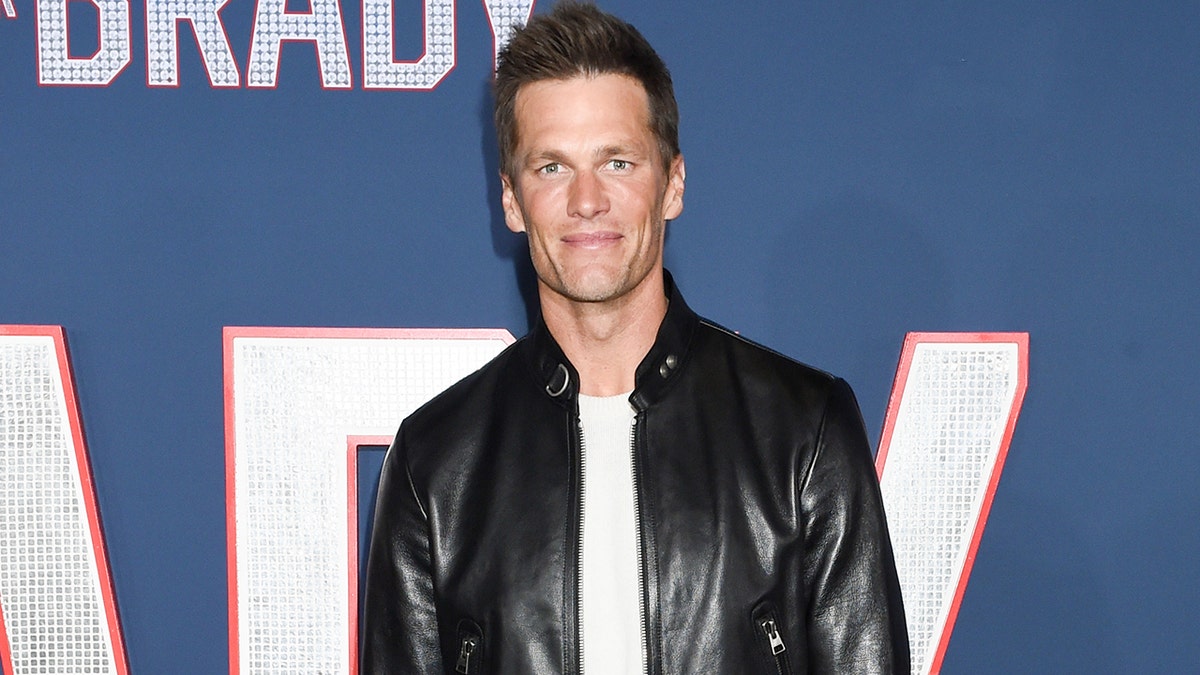 Tom Brady wears leather jacket and white T-shirt on red carpet of film premiere