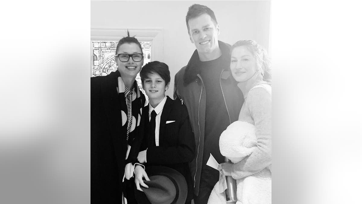 In a black and white photo, Tom Brady and his then wife Gisele Bündchen pose with his son Jack, and his mom Bridget Moynahan