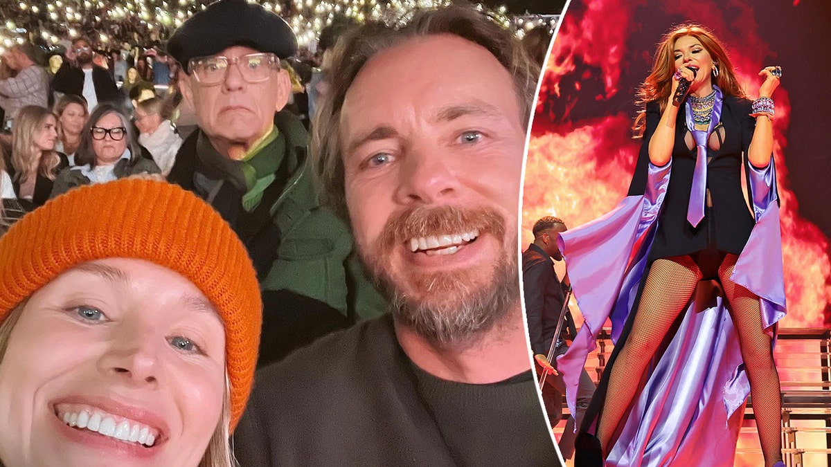Kristen Bell in an orange beanie smiles with Dax Shepard at the Shania Twain concert at the Hollywood Bowl with Tom Hanks photobombing in the background split Shania Twain on stage performing with fire imagery around her