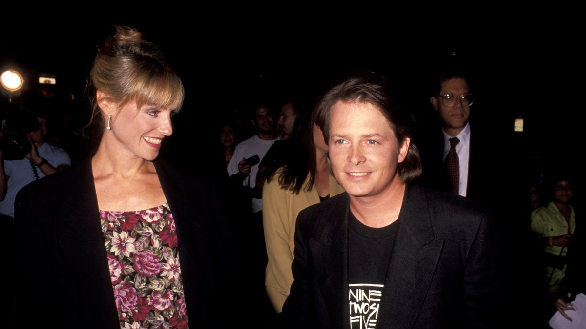 Michael J. Fox holds hands with wife Tracy Pollan in 1991.