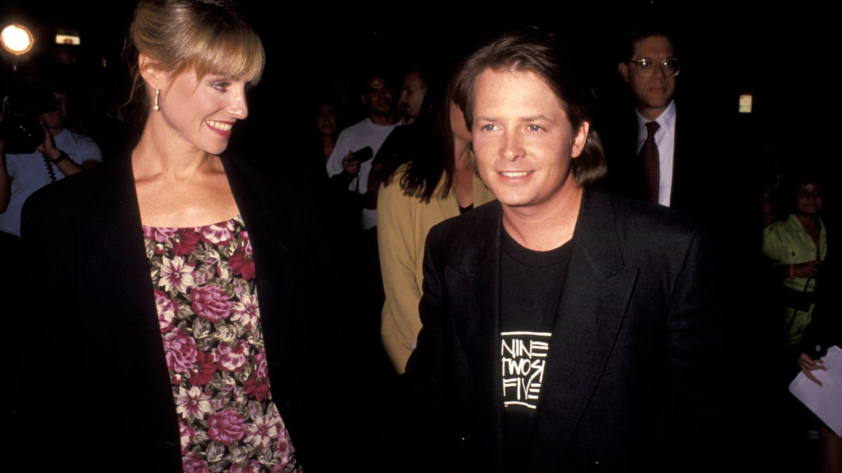 Michael J. Fox holds hands with wife Tracy Pollan in 1991.