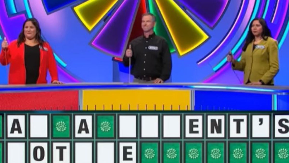 Wheel of Fortune contestants guessing the toss up