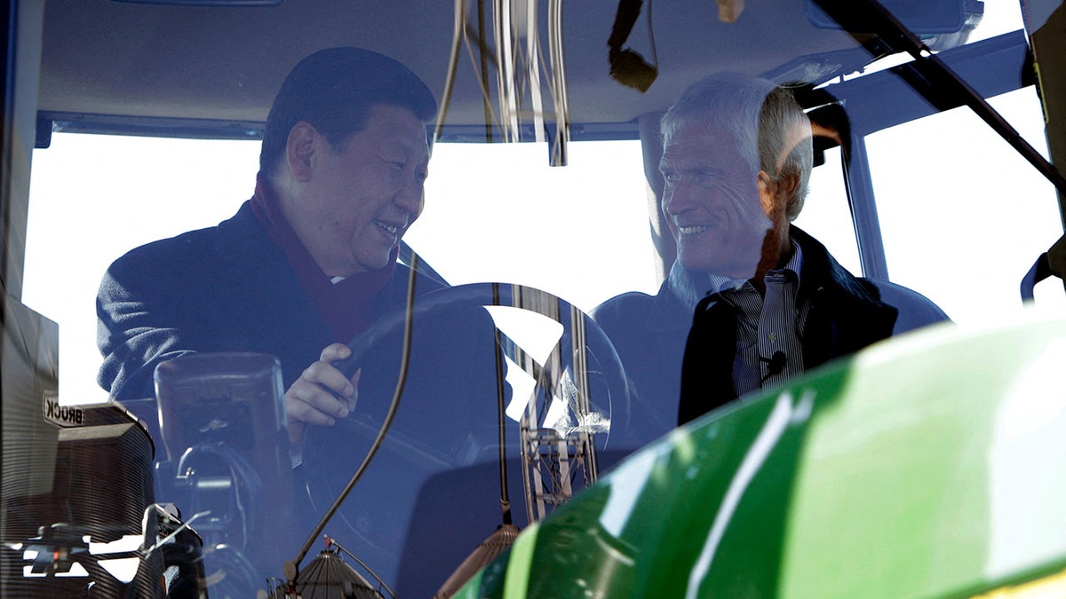 Xi Jinping sits in a tractor with an American farmer