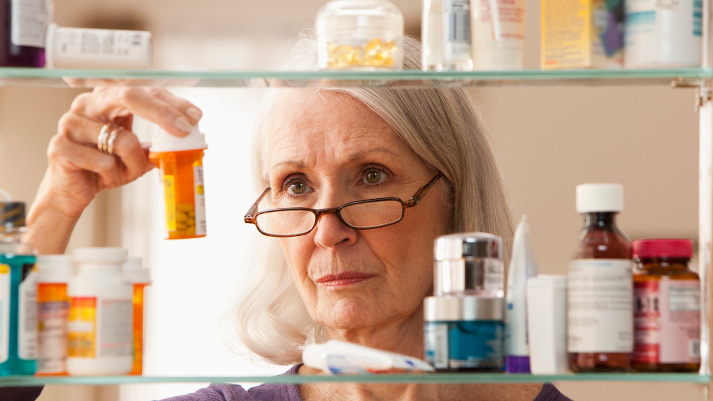 woman at medicine cabinet