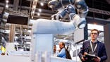 Philip Singer, business architect for data and AI at Hewlett-Packard Enterprises (HPE), operates a robot (developed in cooperation between HPE and German AI startup Aleph Alpha) that is able to speak and answer questions at the HANNOVER MESSE 2023, the Hanover technology fair, in Hanover, Germany on April 17, 2023. - The fair runs from April 17 until April 21, 2023. (Photo by Axel Heimken / AFP) (Photo by AXEL HEIMKEN/AFP via Getty Images)