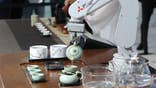 SHANGHAI, CHINA - NOVEMBER 09: A Mitsubishi Electric mechanic arm imitates the movements of a tea art specialist during the 3rd China International Import Expo (CIIE) at the National Exhibition and Convention Cente on November 9, 2020 in Shanghai, China. (Photo by Zhang Hengwei/China News Service via Getty Images)