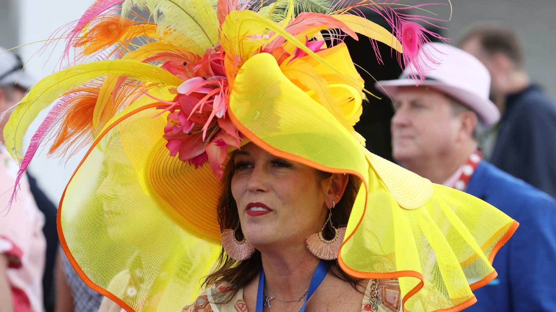 Woman wears a large yellow hat to the Kentucky Derby.