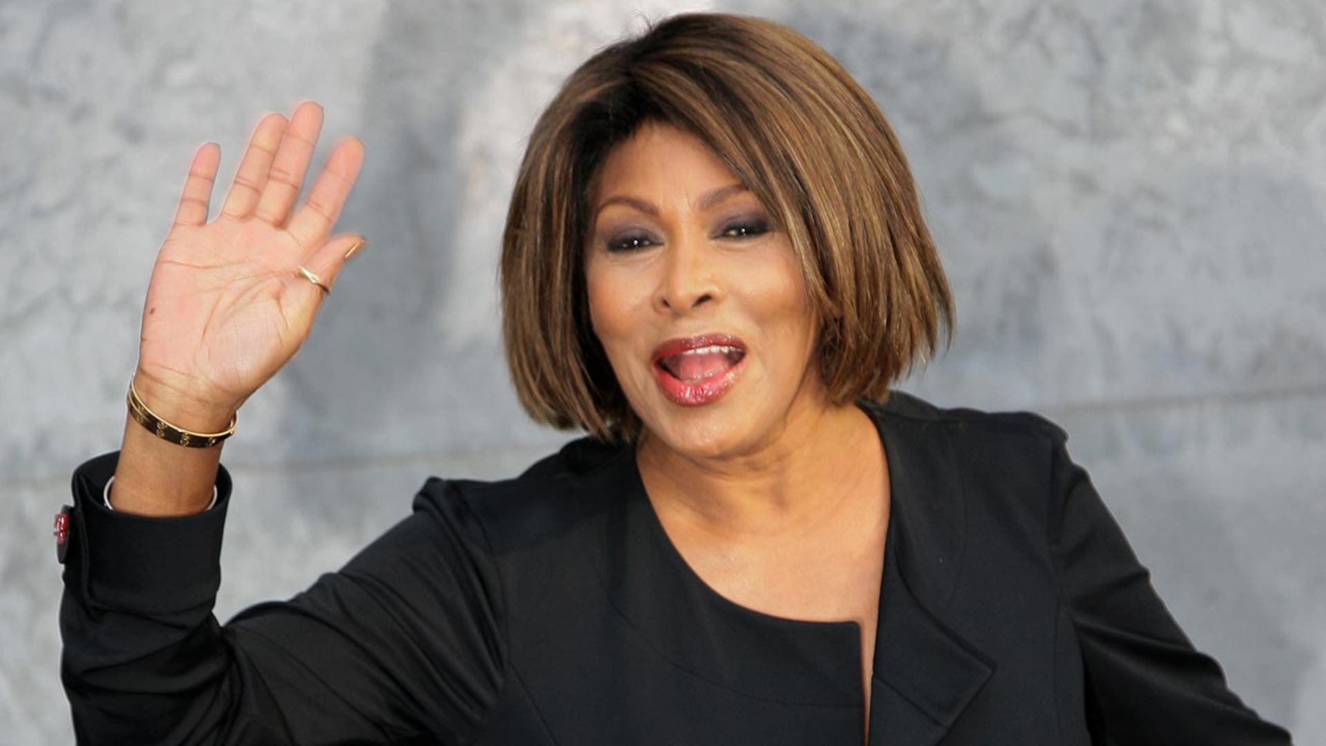 Tina Turner, who died in 2023, waving at the camera