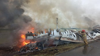 Fiery crash in northern Mexico leaves at least 26 dead after passenger van and freight truck collide