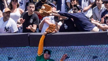 Yankees fan snatches fly ball from Athletics outfielder; umpires rule it home run