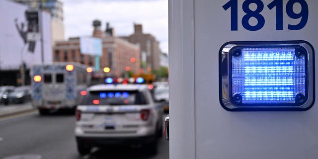 NYPD vehicles wait on the street