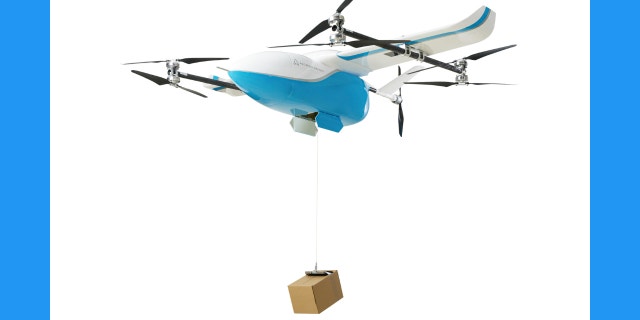Photo of a drone carrying a box.