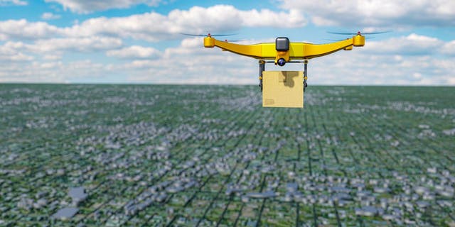 Yellow drone flies over city 