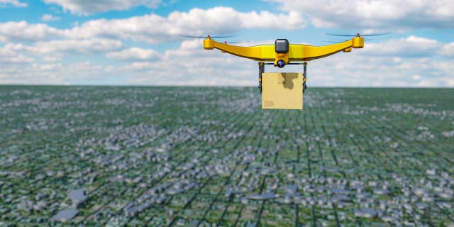 Yellow drone flies over city 