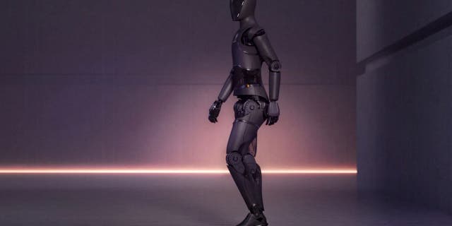 Humanoid robot walking from right to left.