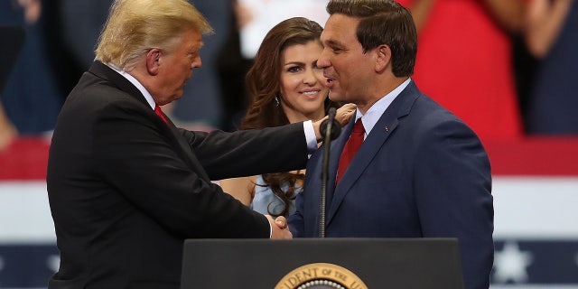 Donald Trump and Ron DeSantis shake hands