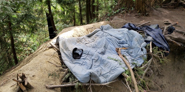Black bra on a light blue blanket on the ground