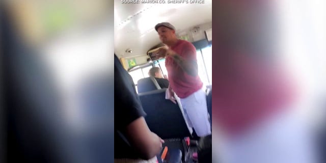 Parents seen on a bus allegedly hitting a school employee