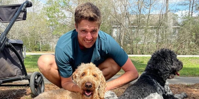 Colby Richards poses with his dogs outside