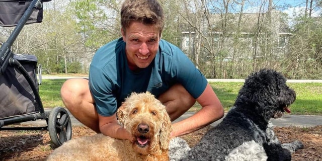 Colby Richards poses with his dogs outside