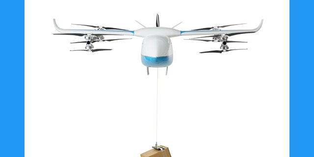 The drone is flying forward carrying a box.