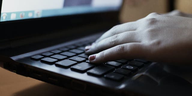 Woman typing on keyboard