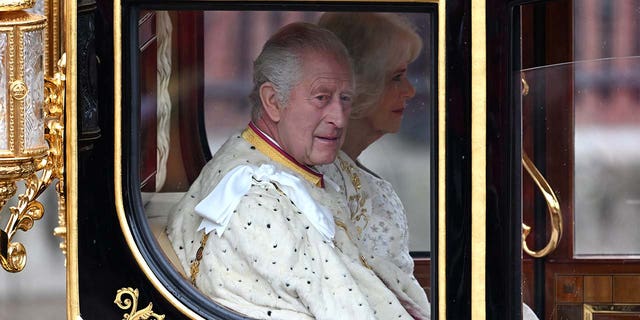 King Charles wearing a royal white robe