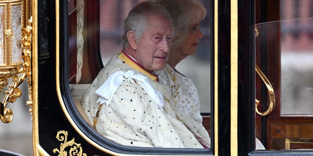 King Charles wearing a royal white robe