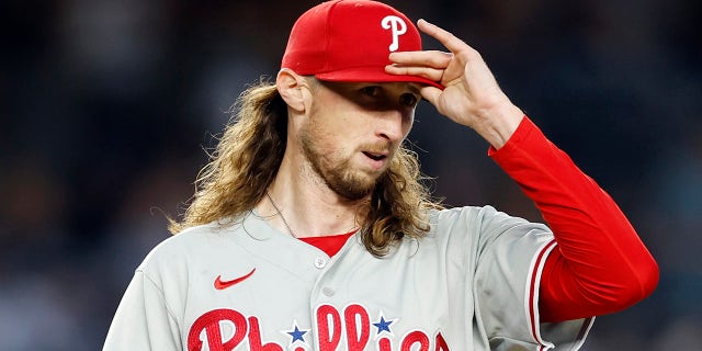 Matt Strahm fixes the hat