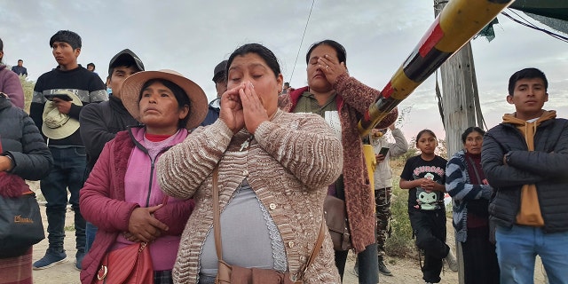 A photo of victims' relatives outside the mine