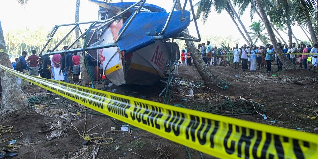 Warning tape in front of an upturned boat