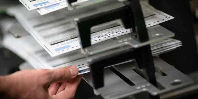 Polll workers sorting out absentee ballots