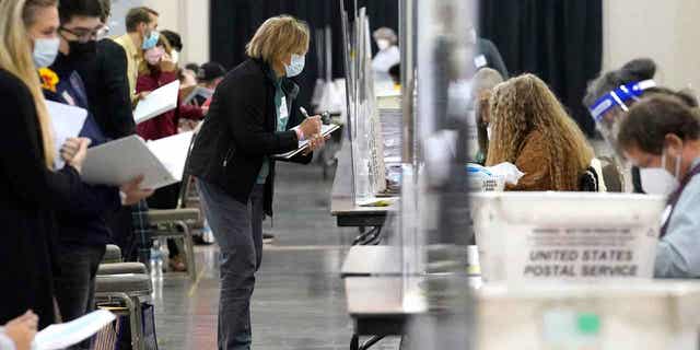 Recount observers watch ballots during a Milwaukee 