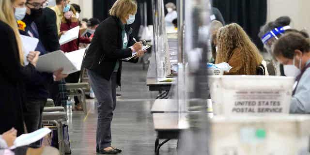 Recount observers watch ballots during a Milwaukee