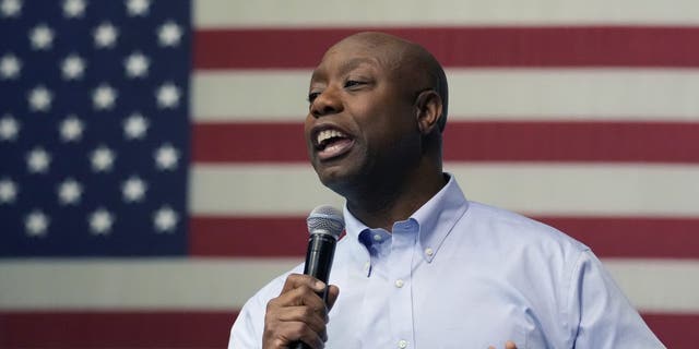 Tim Scott speaking in front of an American flag