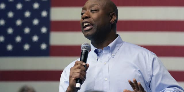 Tim Scott speaking in front of an American flag