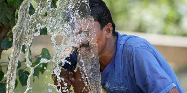Person spraying water on his face