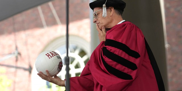 Hanks holding a volleyball