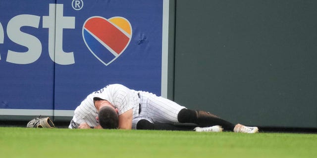 Brenton Doyle lays on the ground in pain