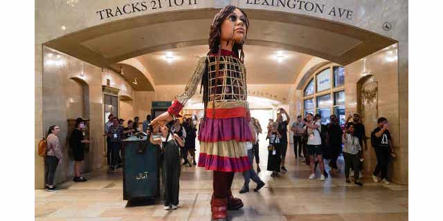 A 12-foot puppet of a 10-year-old Syrian refuge
