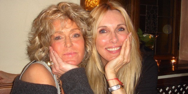 Farrah Fawcett and Alana Stewart wearing matching long sleeved black sweaters