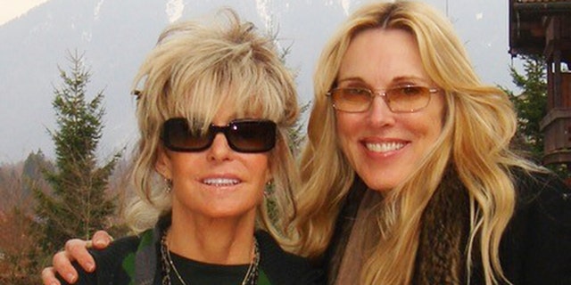 Farrah Fawcett and Alana Stewart wearing black while Farrah Fawcett wears black sunglasses